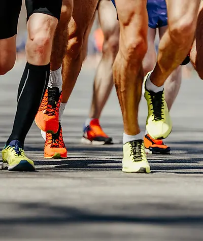 Close up of men's shoes while running during a race